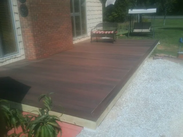 Freshly stained wood deck built against a brick home in Mount Vernon