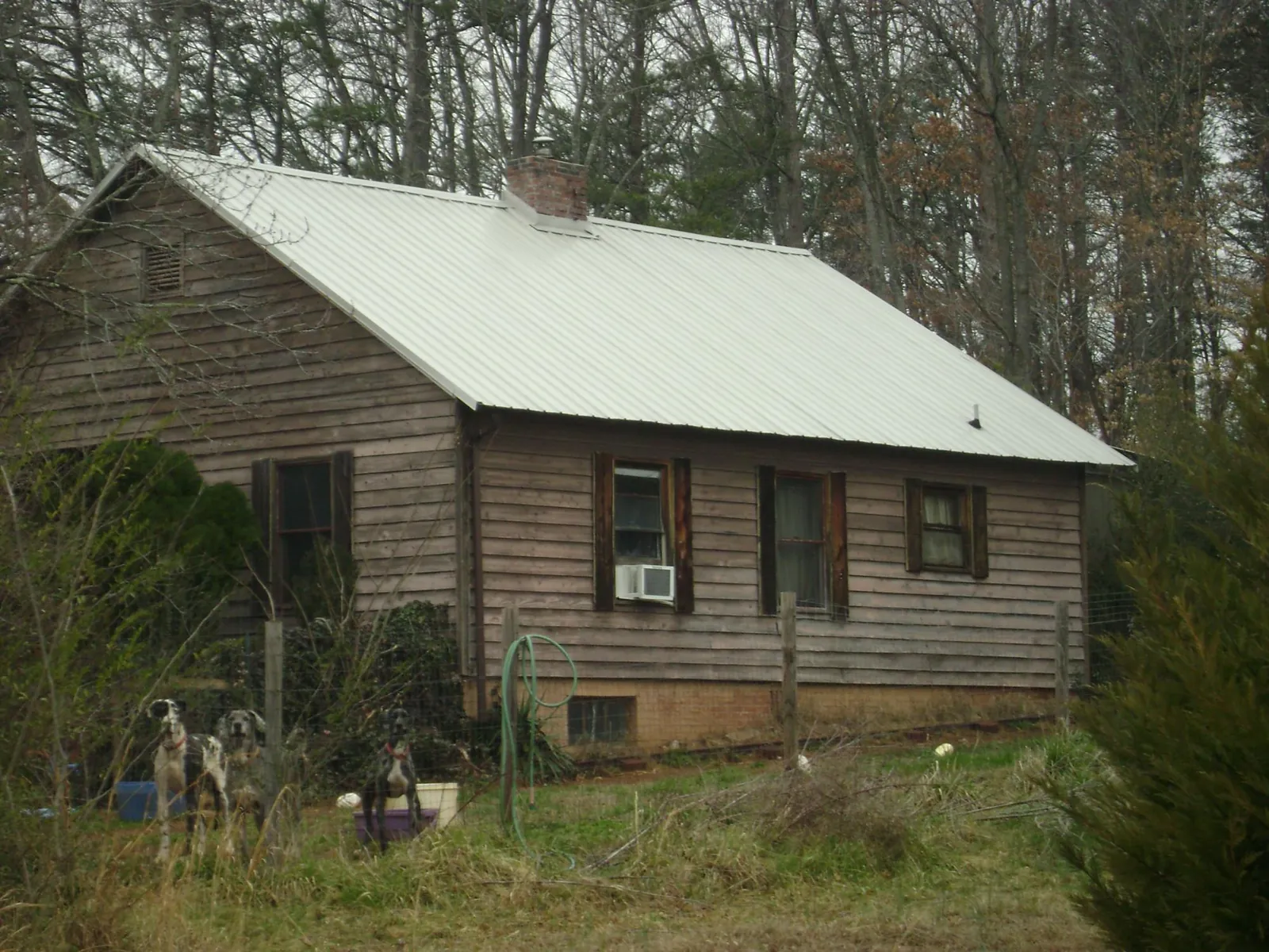 White metal roof on an old wood sided farmhouse, from a Metal Roof Installation job in Mount Vernon